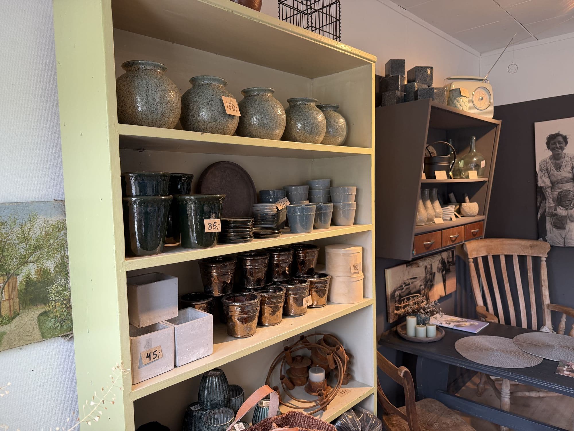 A shelf with ceramic vases and pots for sale