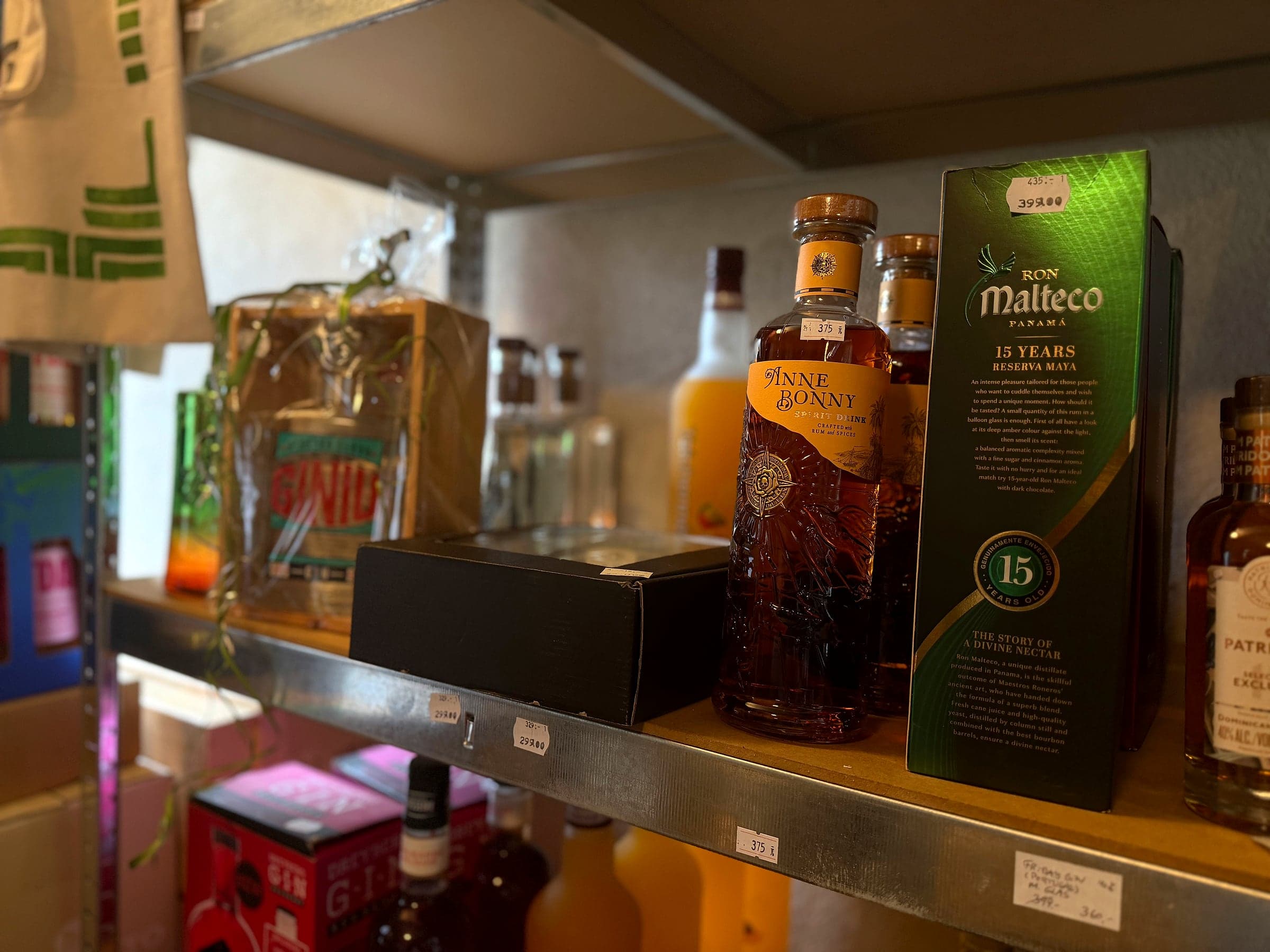 Rum and whisky on the shelf, including Anne Bonny and Ron Malteco