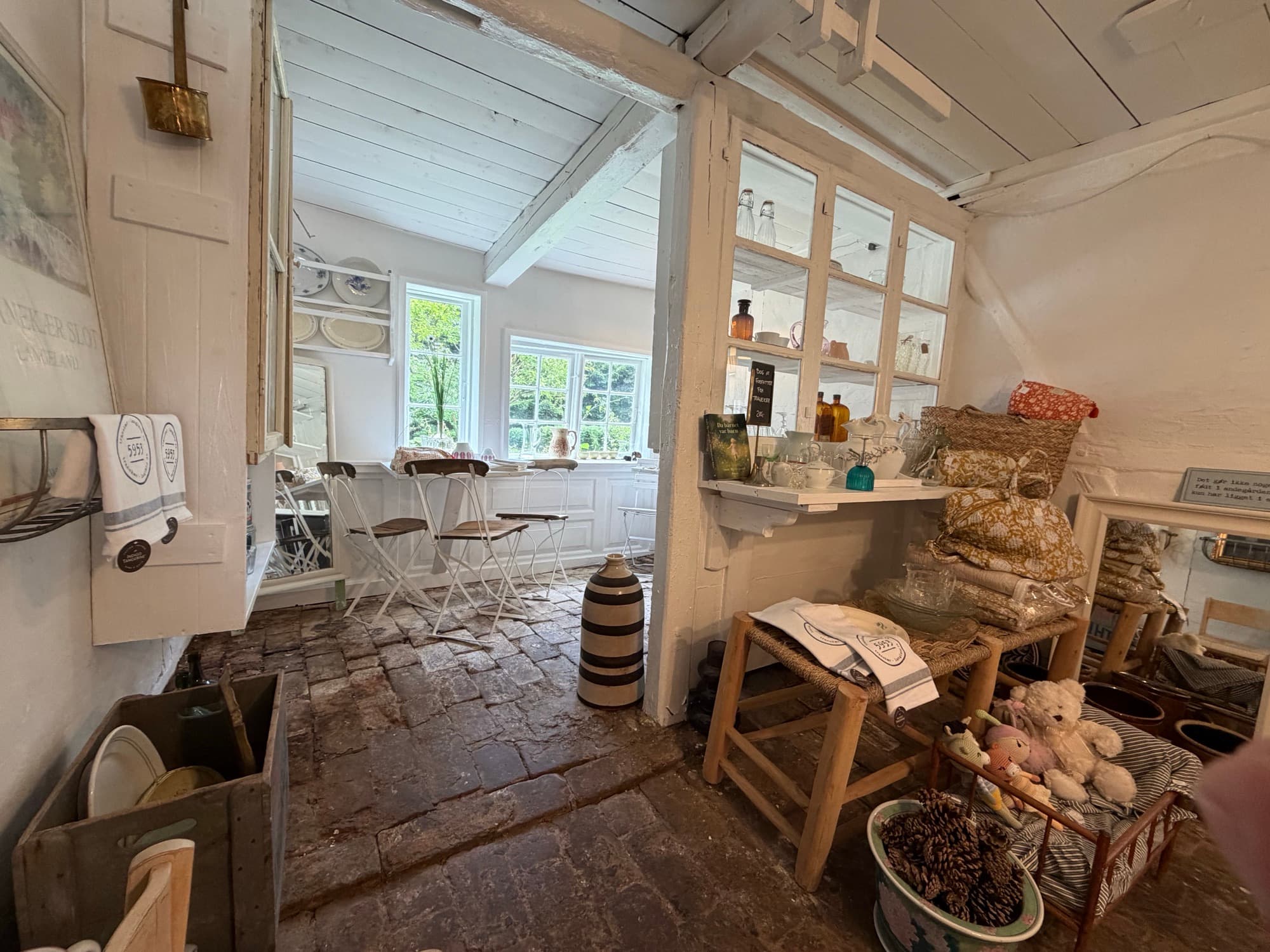 A room with a Tranekær Castle sign and a selection of furniture